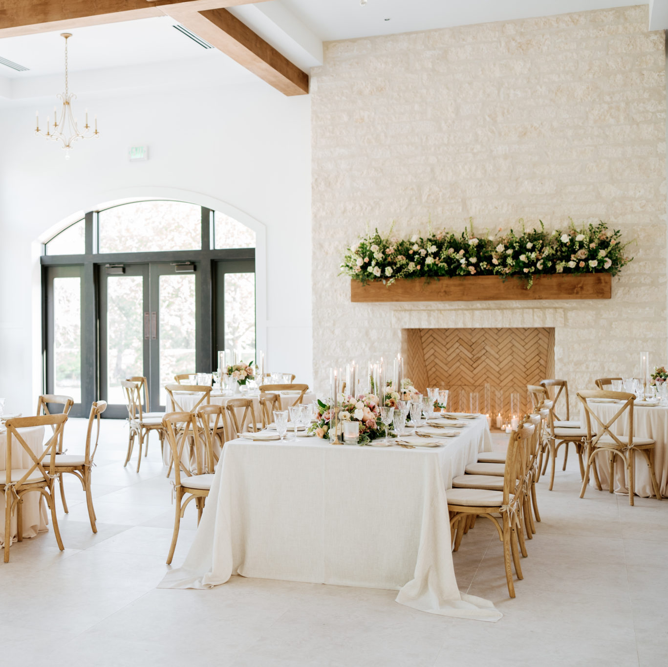 Wedding Venue Ballroom Reception Site with fireplace mantel covered in floral arrangments