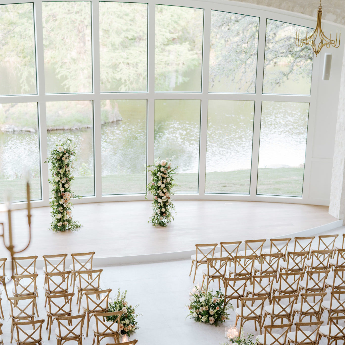 Wedding Chapel with floral arrangements and large floor to ceiling windows