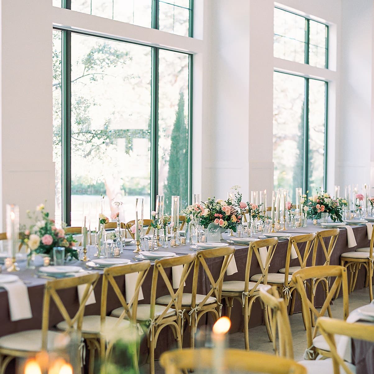 Reception Ballroom with a long head table decorated with tall candles and floral arrangements