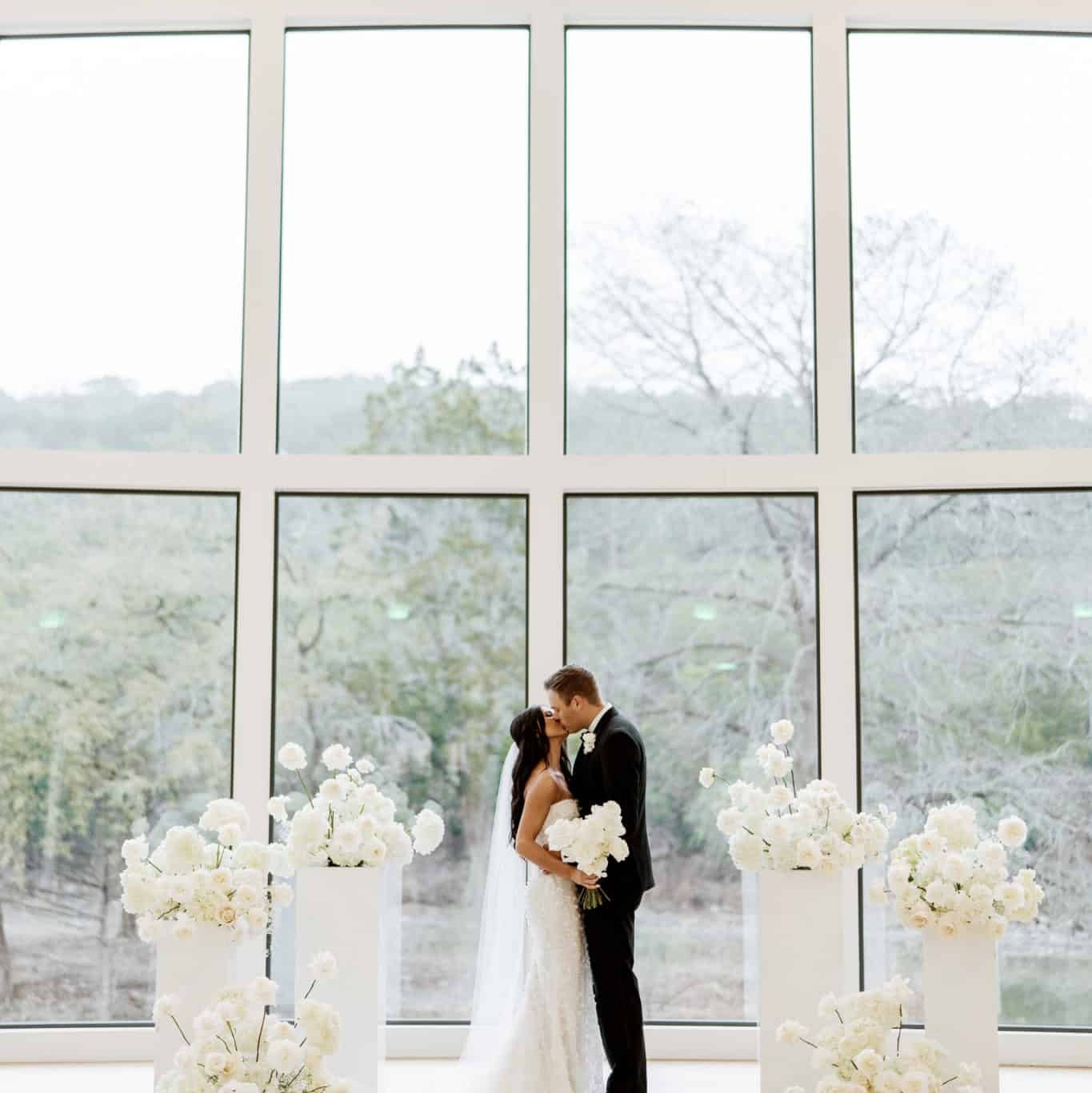 Wedding ceremony in our chapel with Black and White Wedding theme with large windows overlooking the Texas hill country