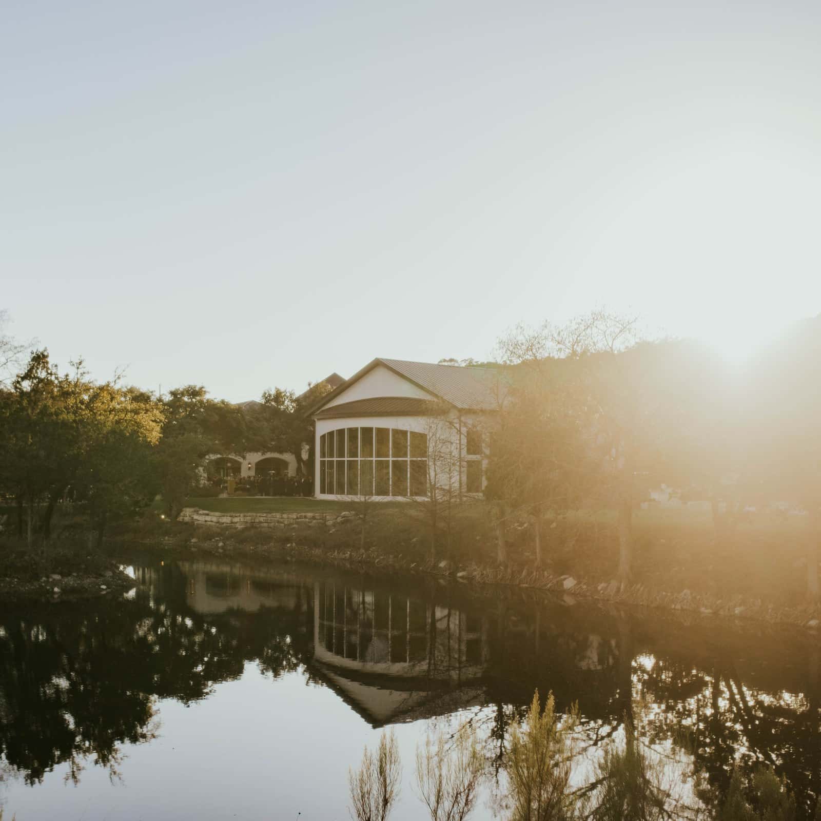 The Preserve at Canyon Lake wedding venue reflected in the water at sunset